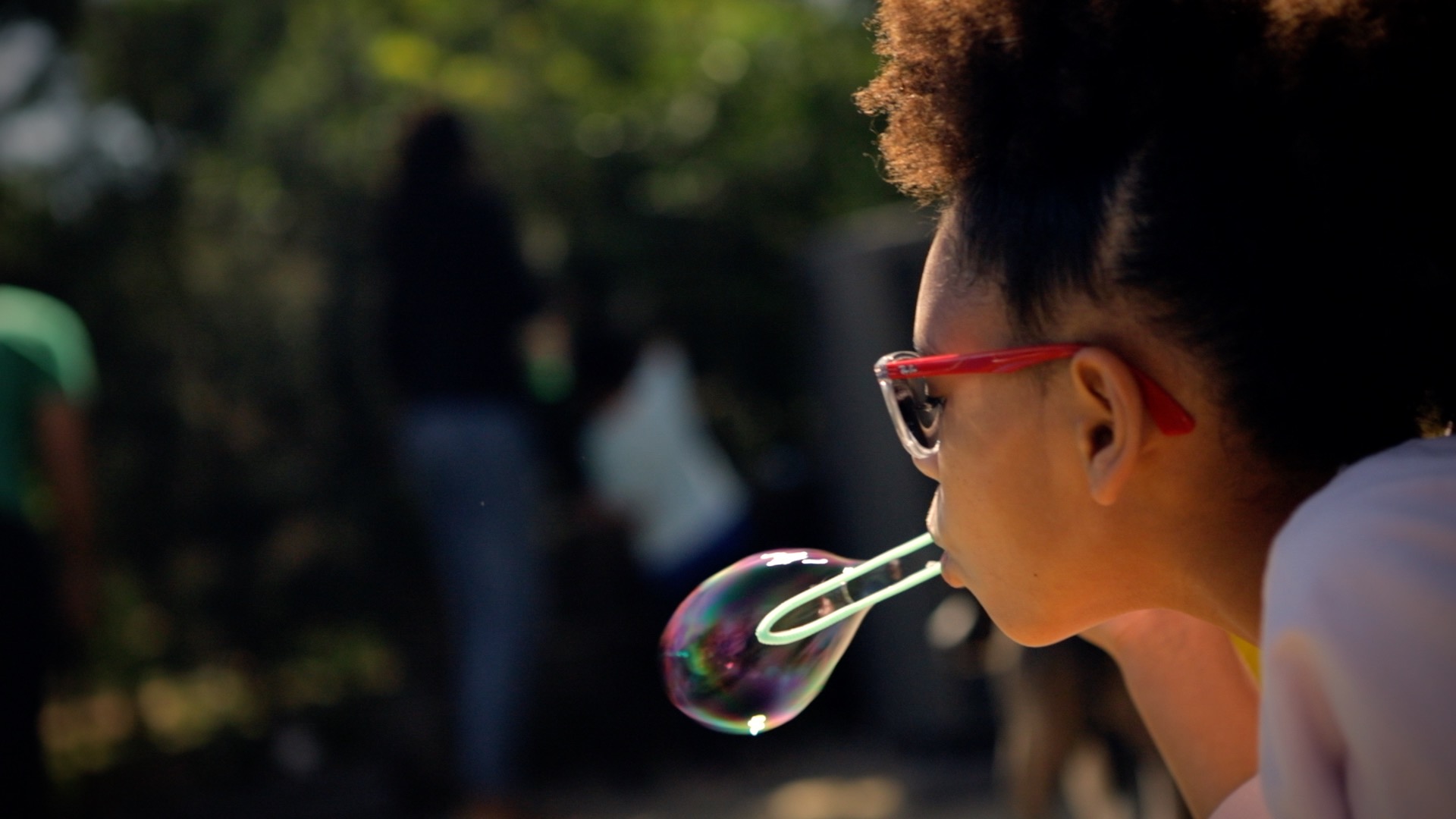 a girl blowing a bubble