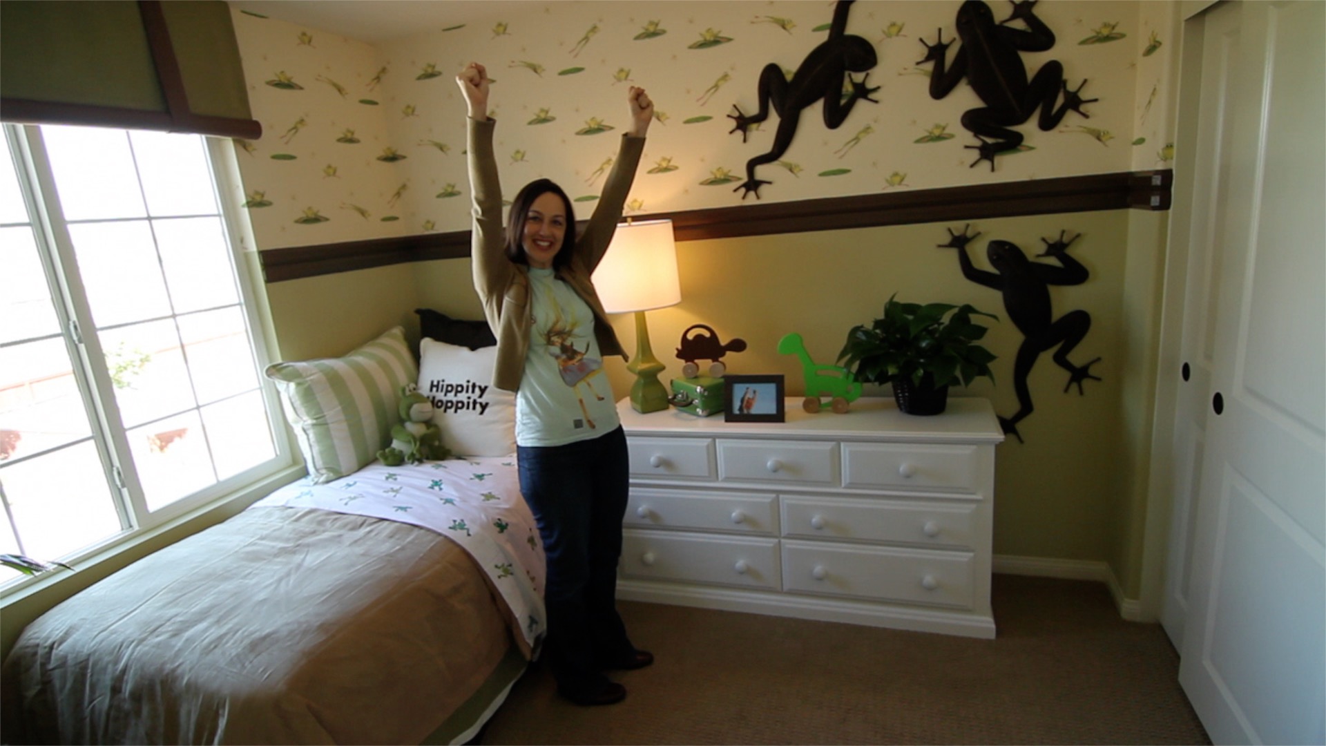 a woman in a room decorated with frogs