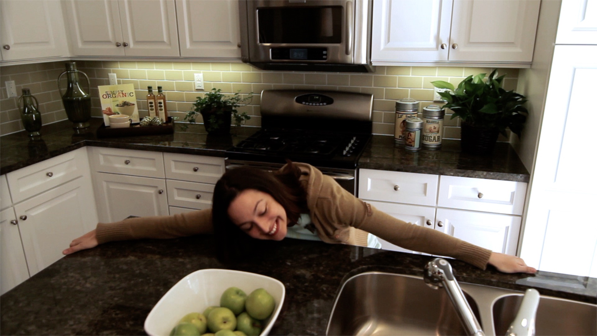 a woman hugging a kitchen countertop