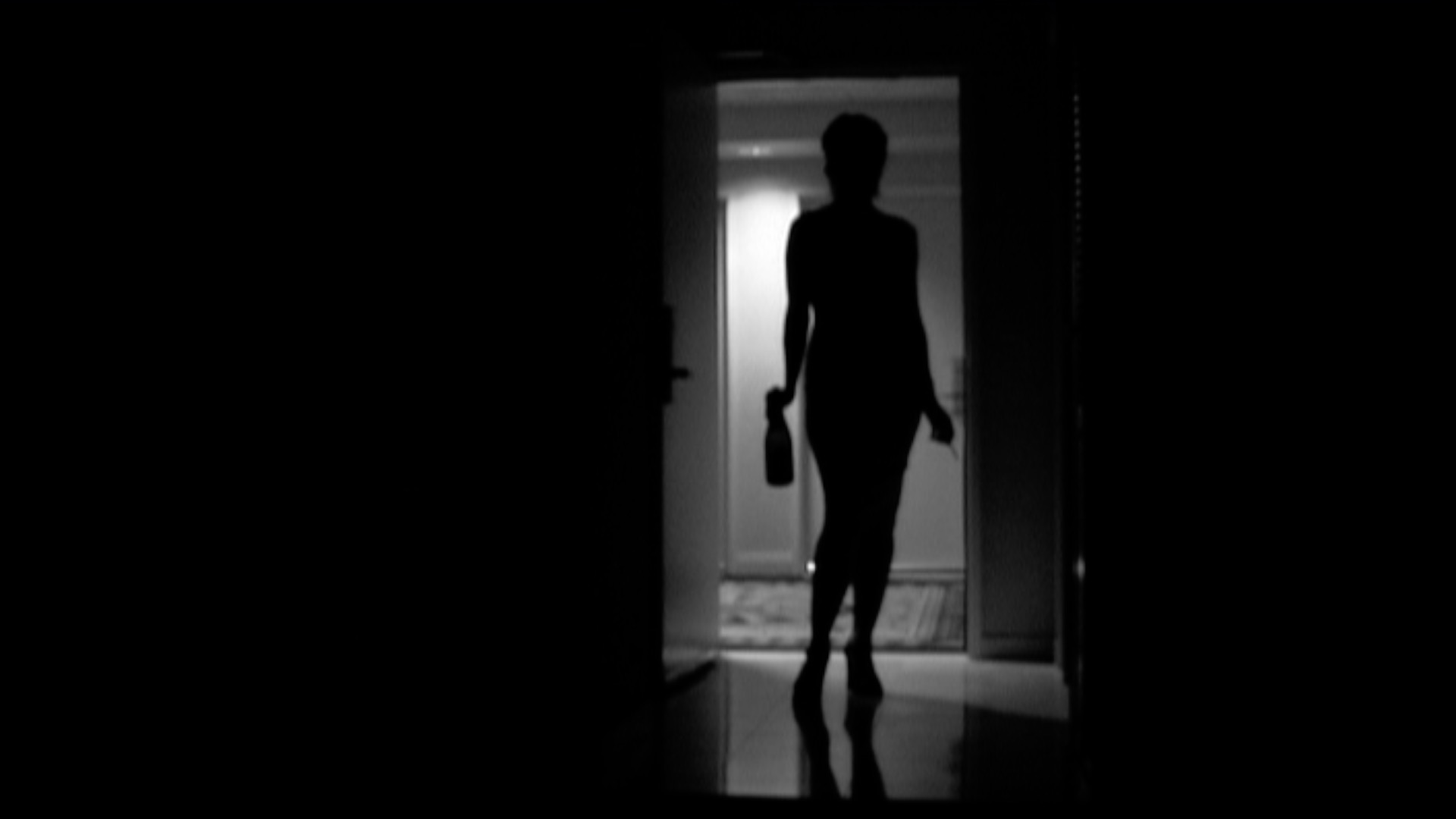 a woman in silhouette in a doorway