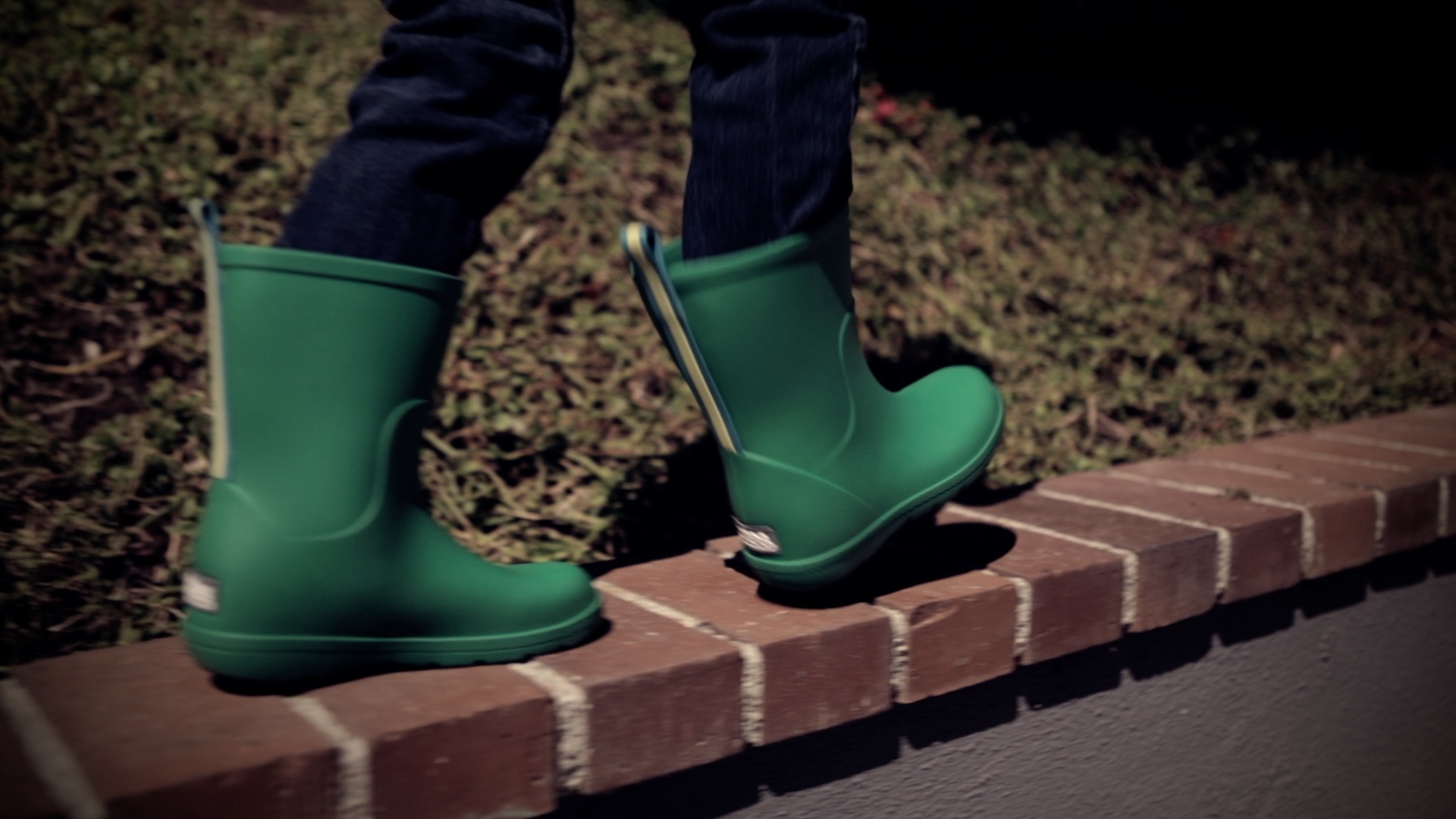 a close up of green rubber boots