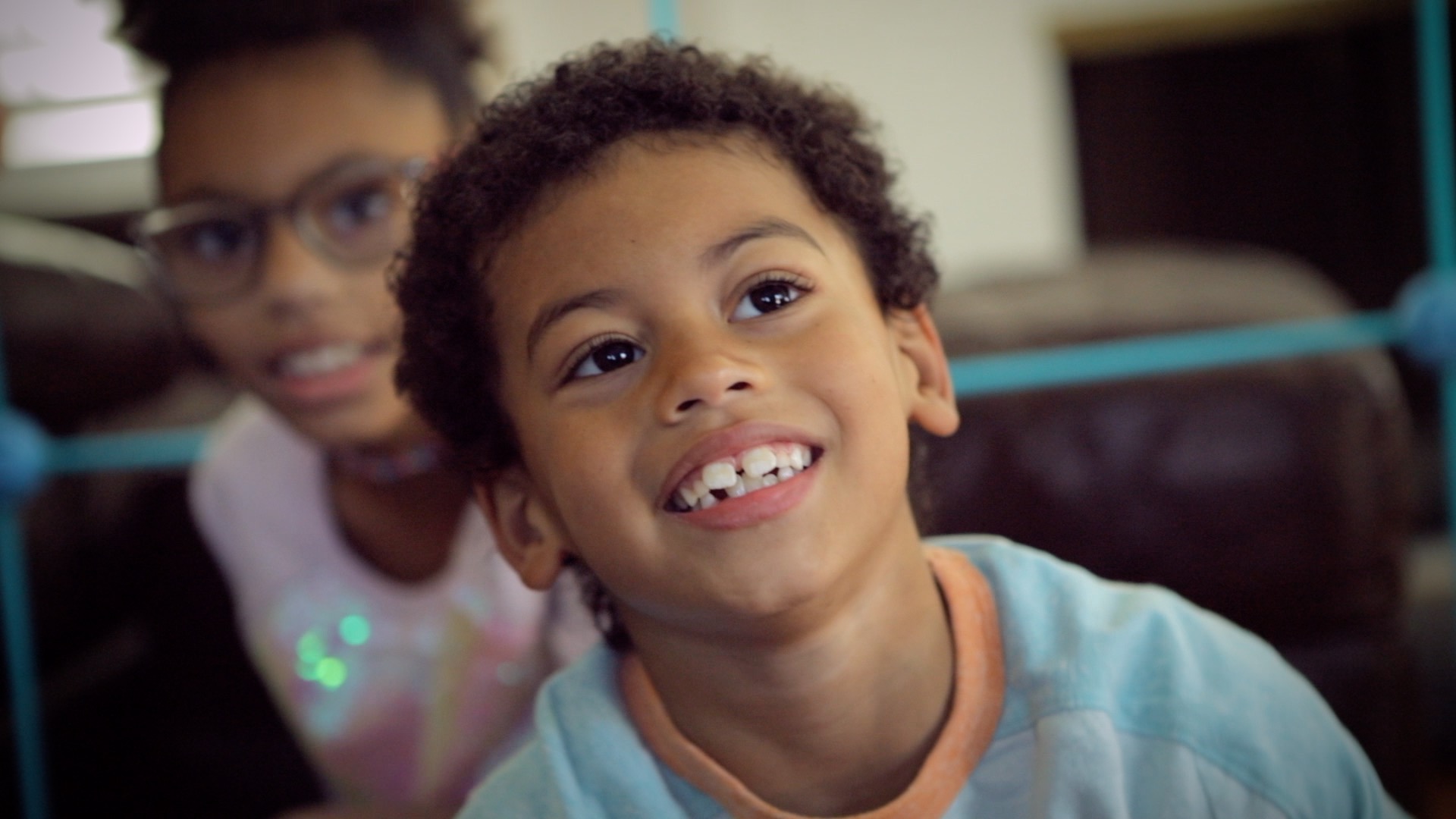 a close up of two kids smiling